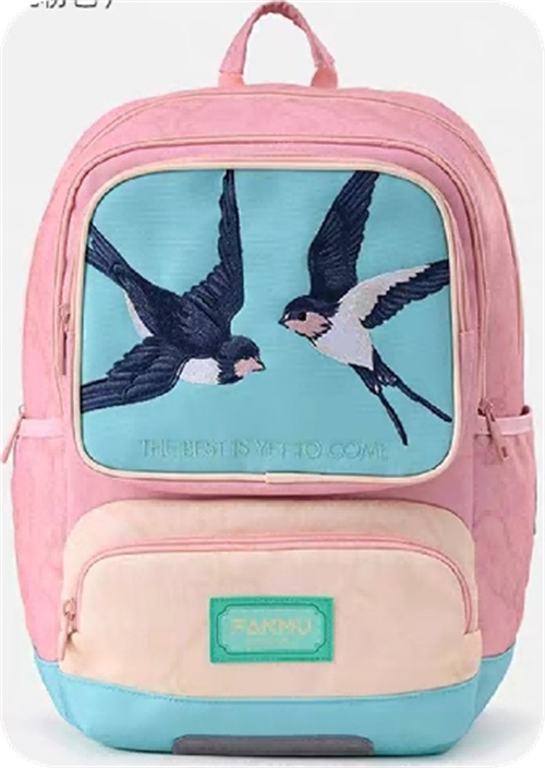 Flat embroidered bird motif on a pink backpack