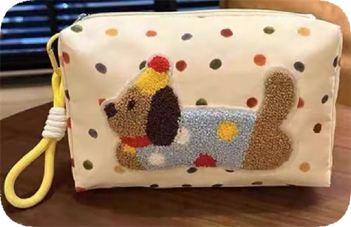 Chenille dog motif on a cosmetic pouch