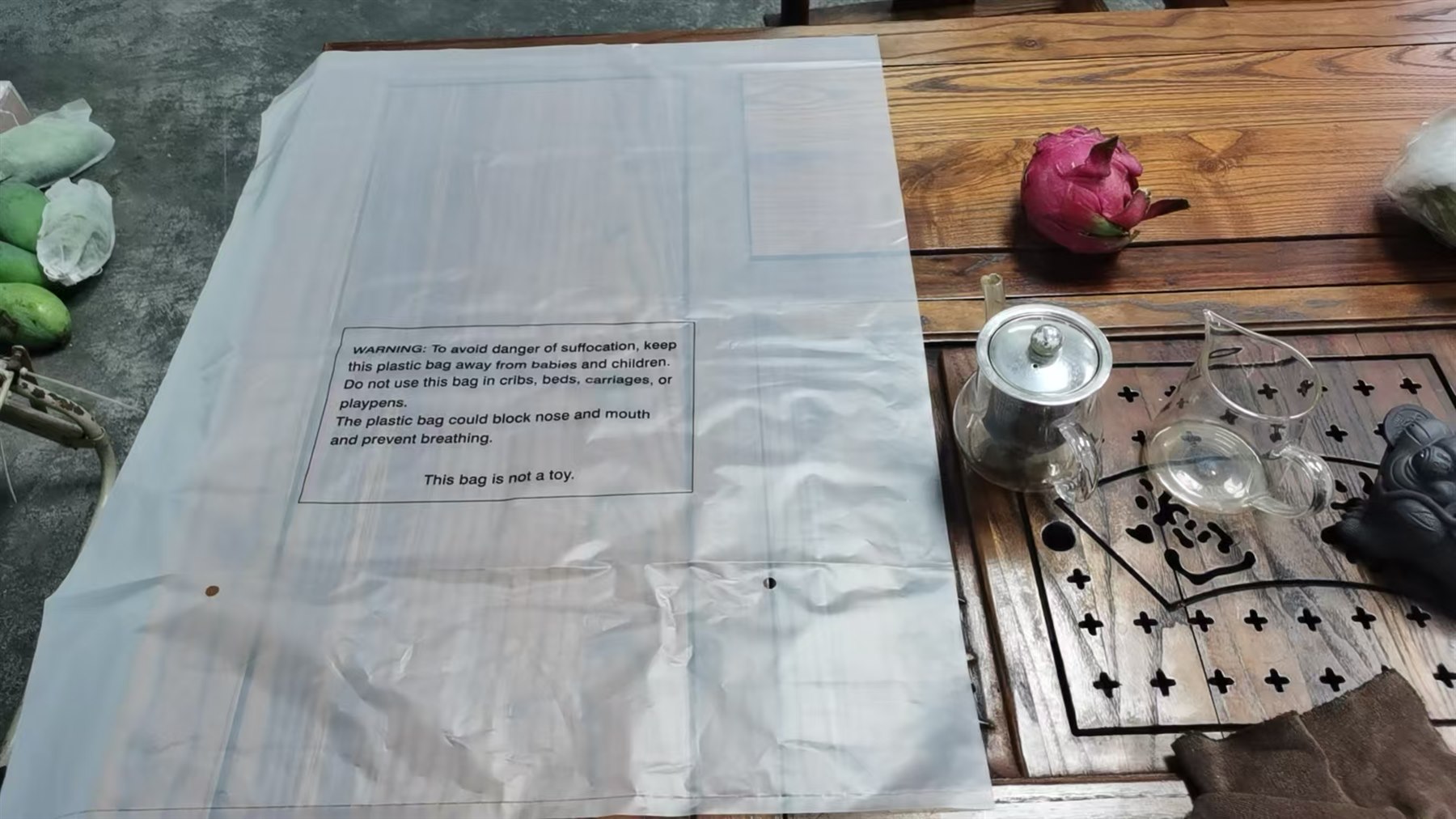 PVC backpack packed in a printed polybag with a suffocation warning and ventilation holes