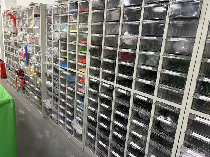 Organized storage bins holding bag trims and hardware